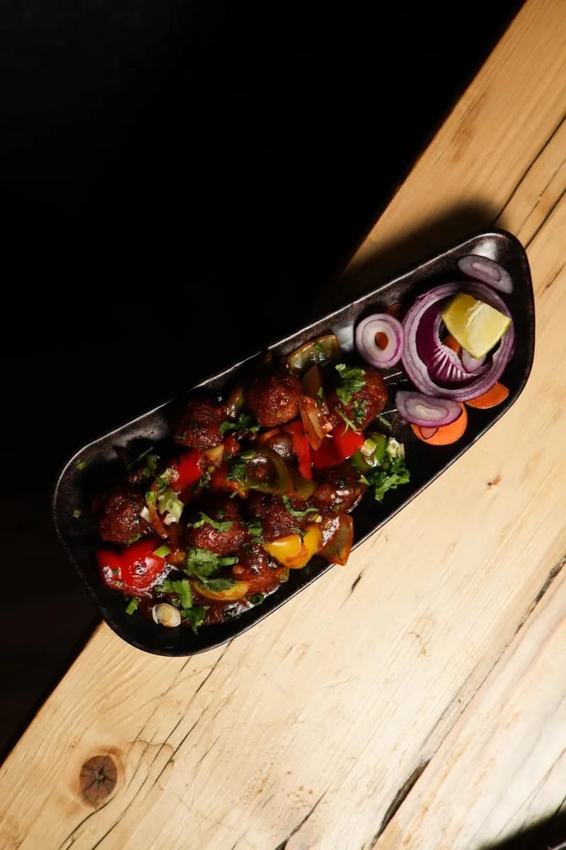 Indo-Chinese starter with crispy vegetable balls in tangy Manchurian sauce